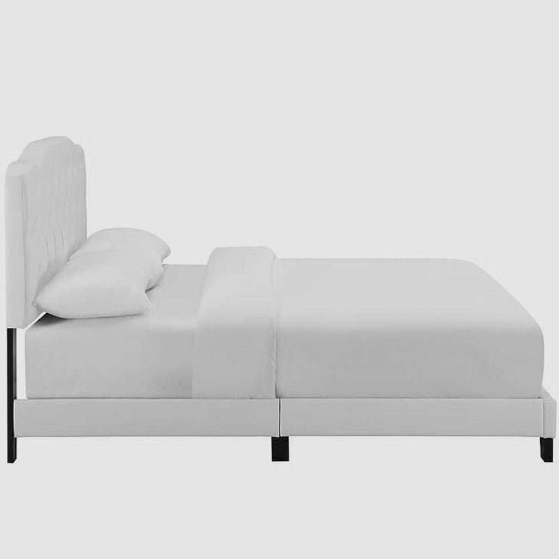 Lit plateforme en cuir avec tête de lit capitonnée